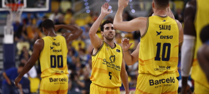 Jugadores del Gran Canaria celebran una jugada en un partido de baloncesto.