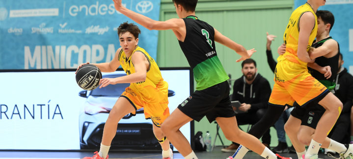Jugadores de baloncesto en acción durante un partido de la Minicopa, con un jugador driblando.