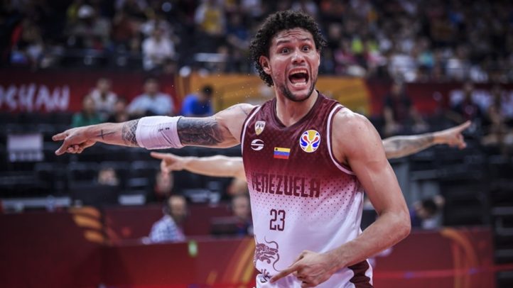 Michael Carrera gesticula intensamente durante un partido de baloncesto.