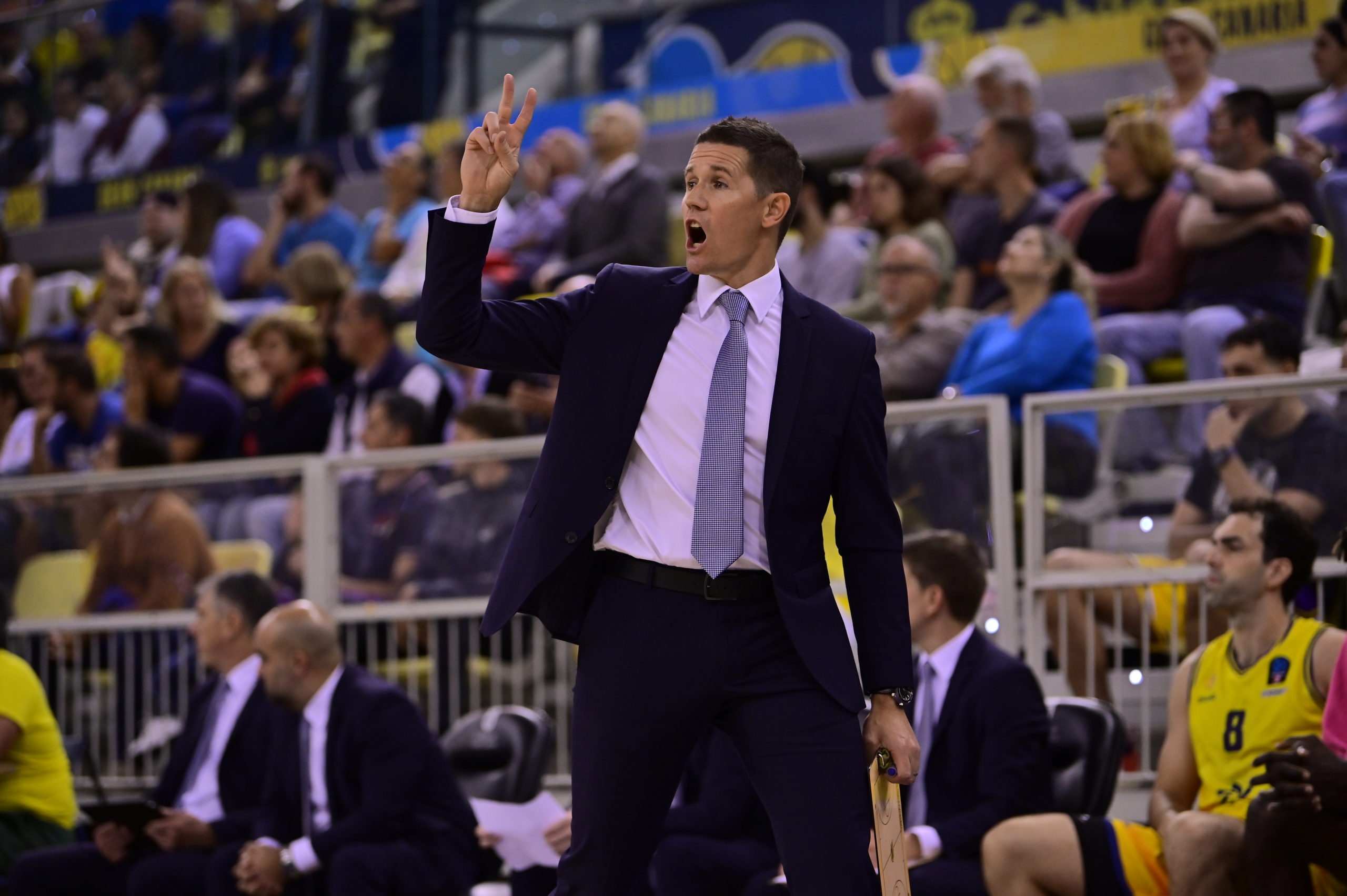 Entrenador Jaka Lakovic dirigiendo al equipo en un partido, gesticulando con entusiasmo.