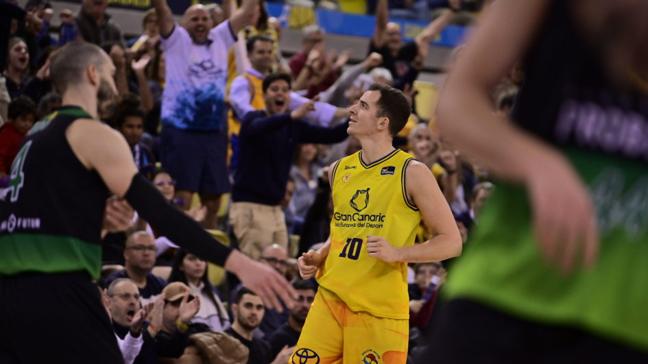 Jugadores del Gran Canaria celebran una victoria emocionante entre el júbilo de los aficionados.
