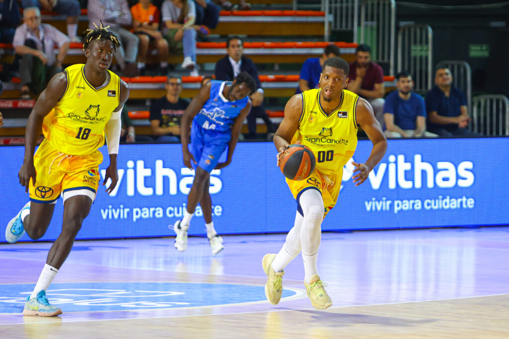 Jugadores del Gran Canaria en acción durante un partido, mostrando una jugada dinámica.