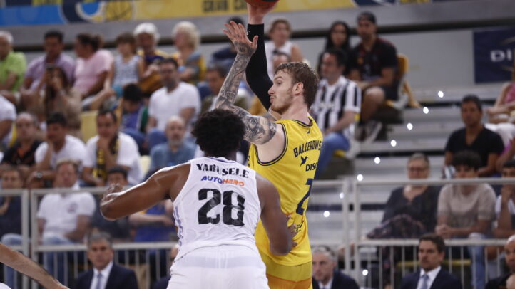 Balcerowski lanza a canasta mientras Yarusele defiende en un partido de baloncesto.