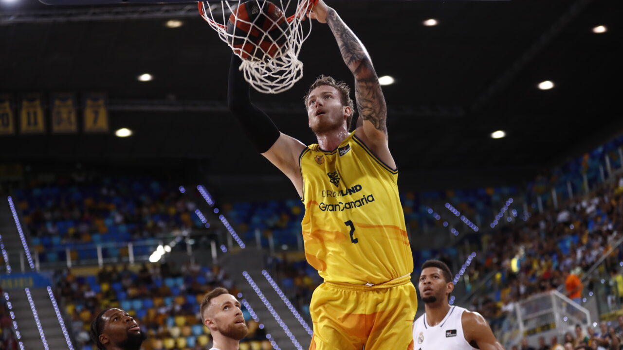 Balcerowski encesta en un partido del Club Baloncesto Gran Canaria, rodeado de rivales.