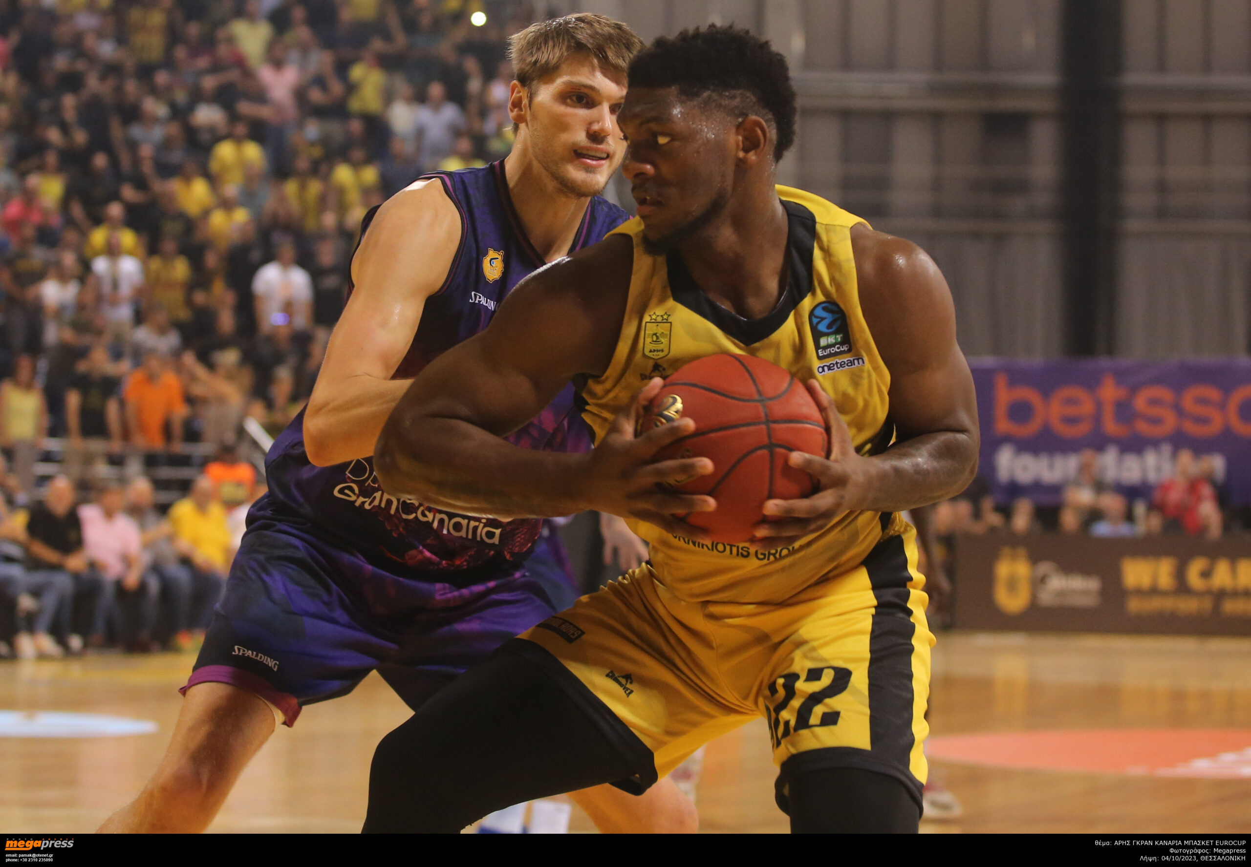 Jugadores de baloncesto compiten por el balón en un intenso partido en Salónica.