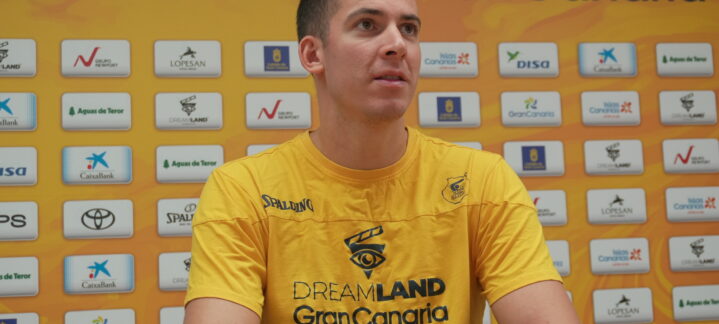 Jugador del Club Baloncesto Gran Canaria en rueda de prensa, con fondo de patrocinadores.