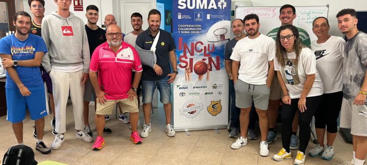 Grupo de personas posando frente a un cartel del Proyecto Suma sobre inclusión.