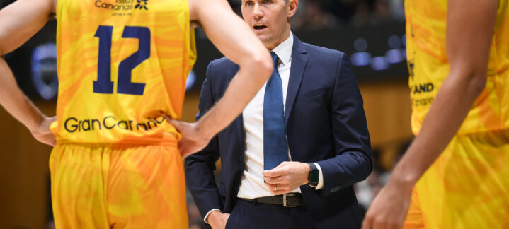Entrenador Jaka Lakovic charlando con jugadores del equipo durante un partido.