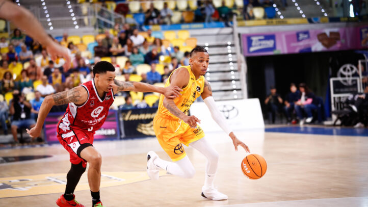 Jugadores de baloncesto compiten en plena acción en un partido.
