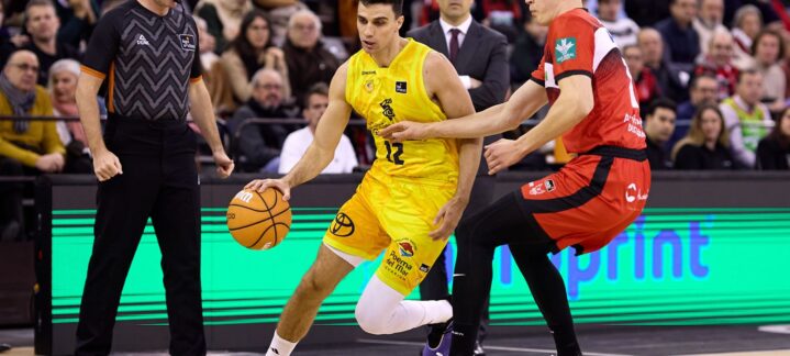 Jugador del Dreamland Gran Canaria dribla mientras es defendido en un partido de baloncesto.