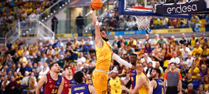 Jugador del Dreamland Gran Canaria atrapa el balón en un salto en medio del partido.