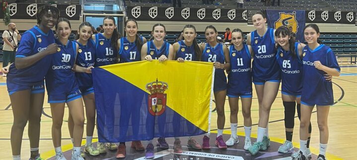 Jugadoras del Gran Canaria femenino posando con la bandera del equipo tras un campeonato.