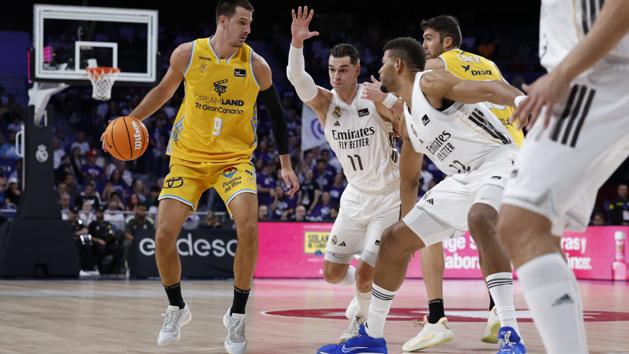 Jugador del Club Baloncesto Gran Canaria driblando ante defensores del equipo rival.